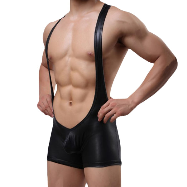 Front view of a model wearing a black faux-leather bodysuit with thin shoulder straps and shorts