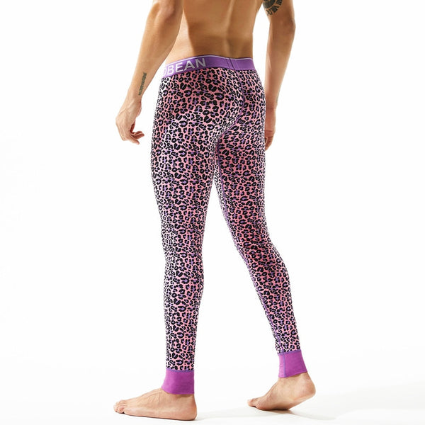 Rear view of a model wearing pink leopard-print thermal leggings with a purple waistband and cuffs