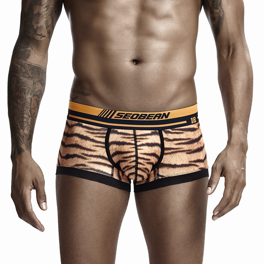 Front view of tiger-print boxers with black trim and orange-and-black branded waistband