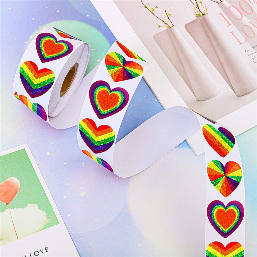 Rolls of rainbow heart stickers showing striped and multicolor heart designs