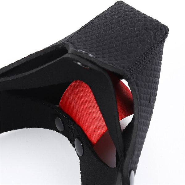 Close-up of a black BDSM dog mask with red inner lining and snap fasteners