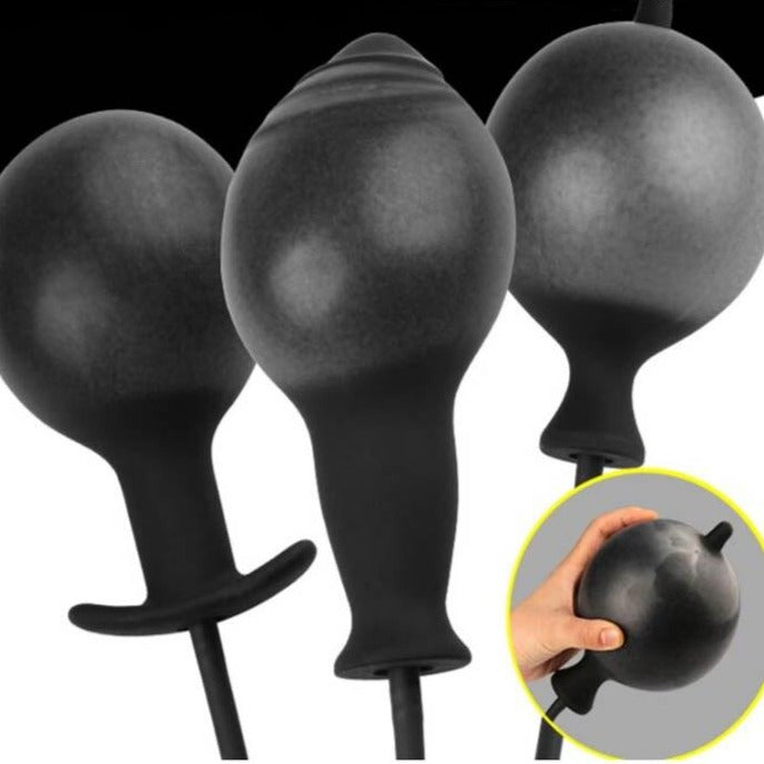Three black inflatable bulb-shaped dildos shown upright, with a hand holding one in an inset