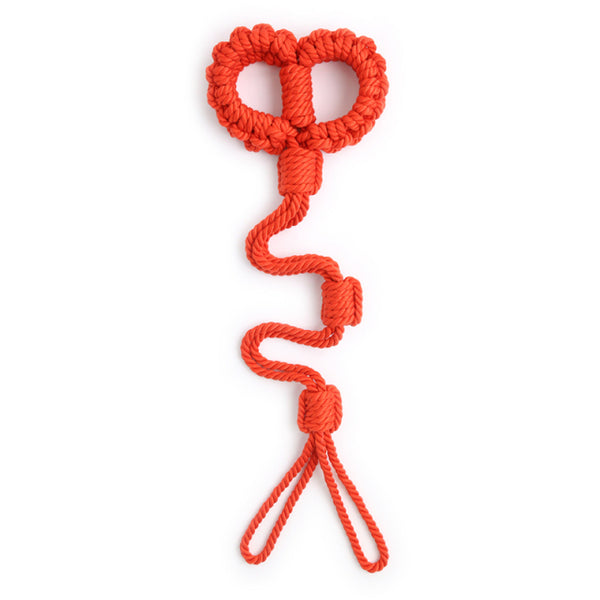 Red braided rope shibari handcuffs arranged vertically on a white background