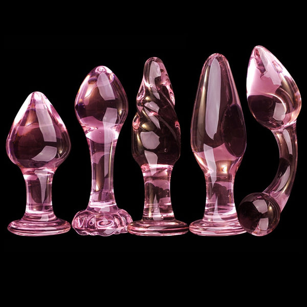 Five pink glass butt plugs with varied bulbous shapes and flared bases on black
