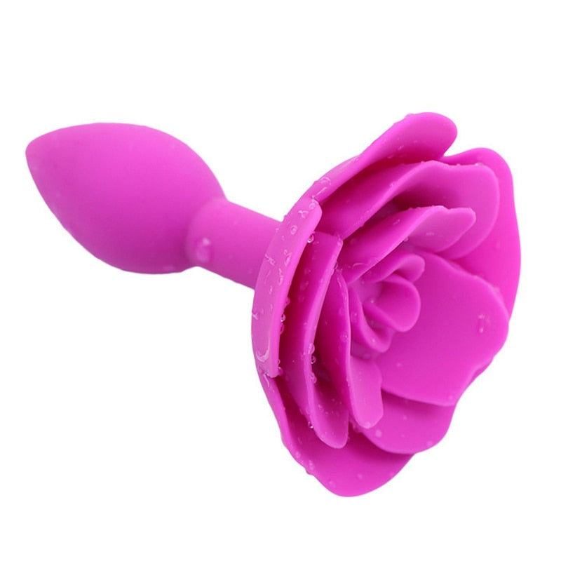 Bright pink silicone rose-shaped butt plug shown at an angled close-up