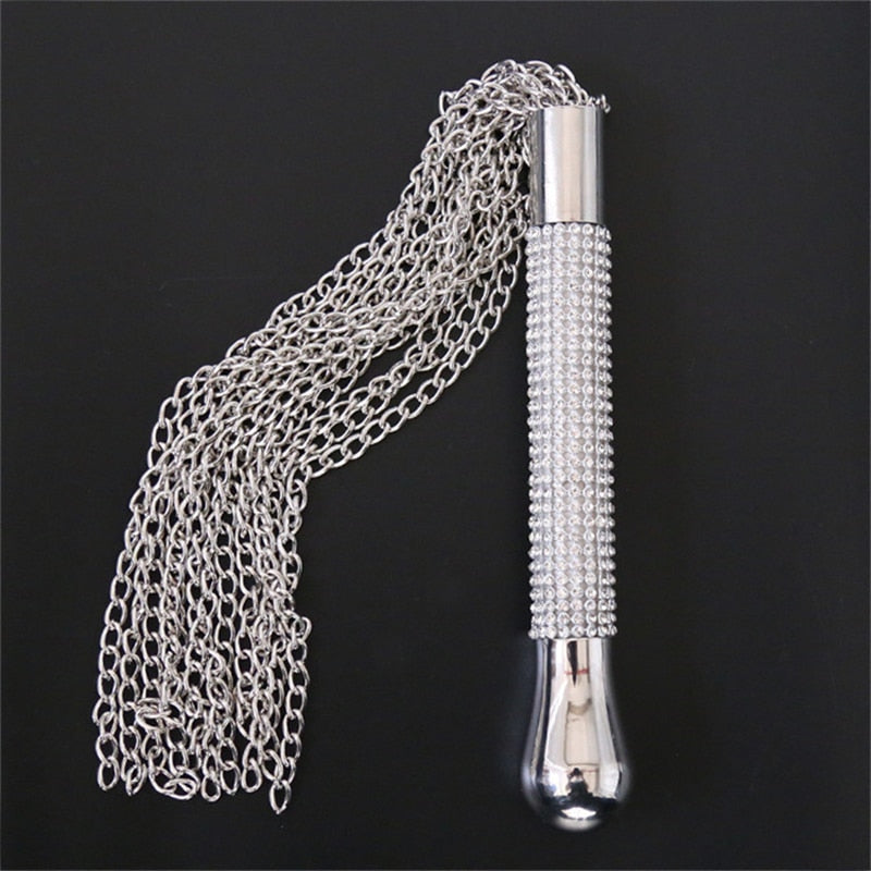 Silver chain whip with a rhinestone-studded handle, displayed against a black background