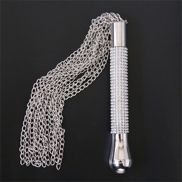 Silver chain whip with a rhinestone-studded handle, displayed against a black background