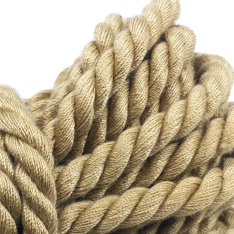 Close-up detail of thick tan braided rope coiled against a white background