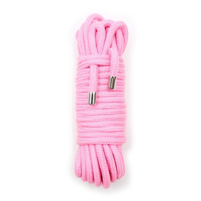 Coiled pink shibari rope with metal-finished ends, shown vertically on a white background