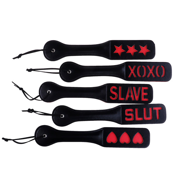 Five black leather paddles with red stars, XOXO, SLAVE, SLUT, and heart designs