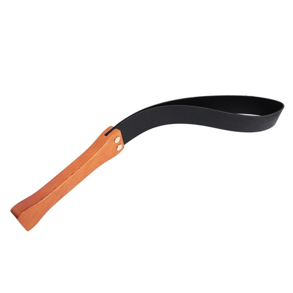 Black leather flogger with a curved looped strap and wooden handle on white