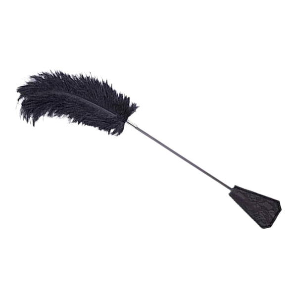 Black feather tickler with a slim handle and lace-covered end on a white background