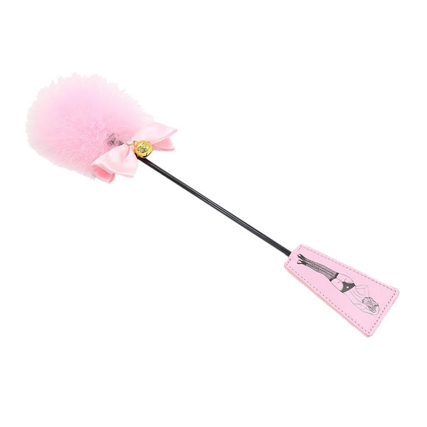 Pink feather-topped whip with a black shaft and illustrated pink handle
