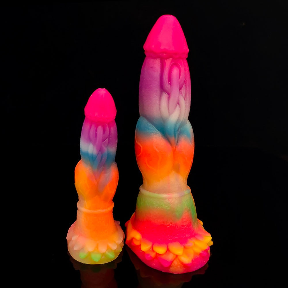 Two upright rainbow-colored dragon dildos with textured bases, shown against a black background