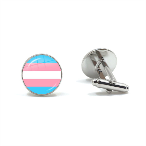 Pair of round silver cufflinks, one showing the transgender pride flag and one turned to reveal its fastening