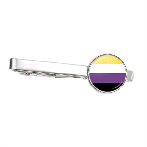 Silver tie clip with a round non-binary pride flag emblem on a white background