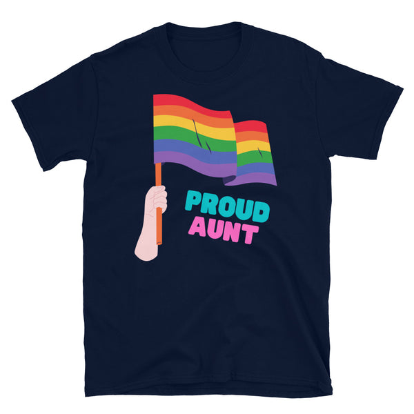 Proud Aunt T-shirt with a rainbow flag drapes over a wooden chair by a dining table topped with plants, rainbow toys, and a card.