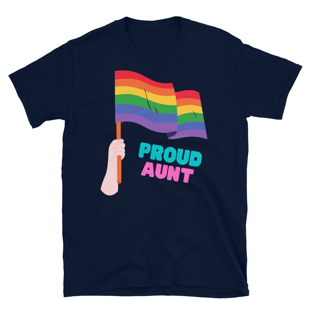 Proud Aunt T-shirt with a rainbow flag drapes over a wooden chair by a dining table topped with plants, rainbow toys, and a card.
