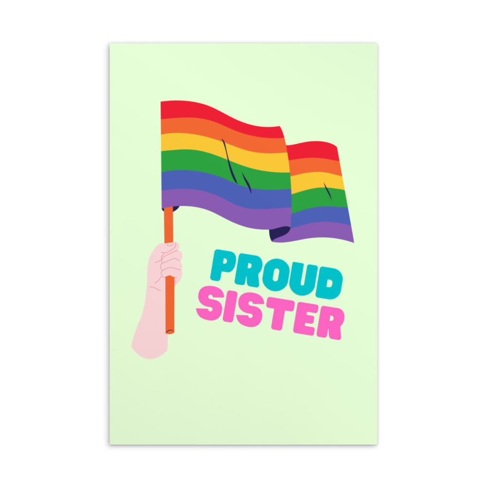 Front of a pale green postcard showing a hand holding a rainbow flag above “PROUD SISTER” text