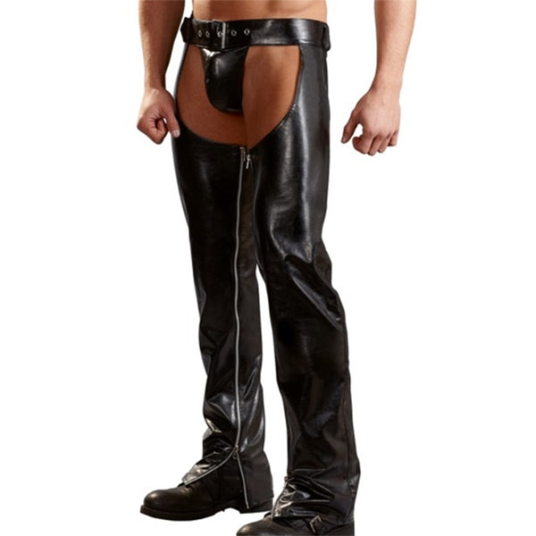 Front view of a model wearing black faux-leather assless chaps with a belt and zippers