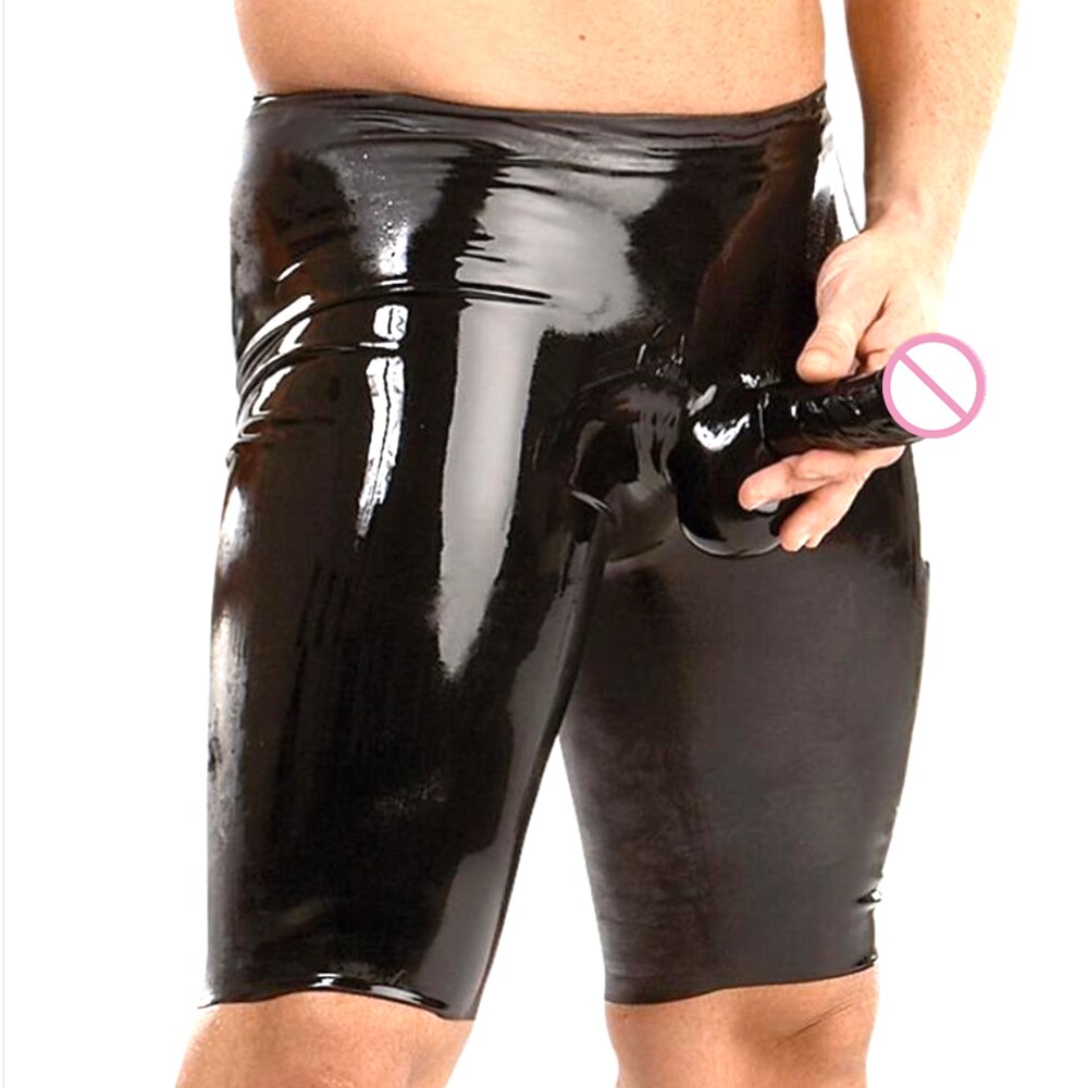 Front view of a model wearing glossy black fetish shorts with a protruding elephant trunk