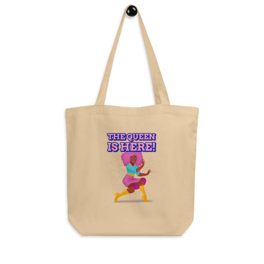 Natural canvas tote bag reading “THE QUEEN IS HERE!” above a colorful dancing woman