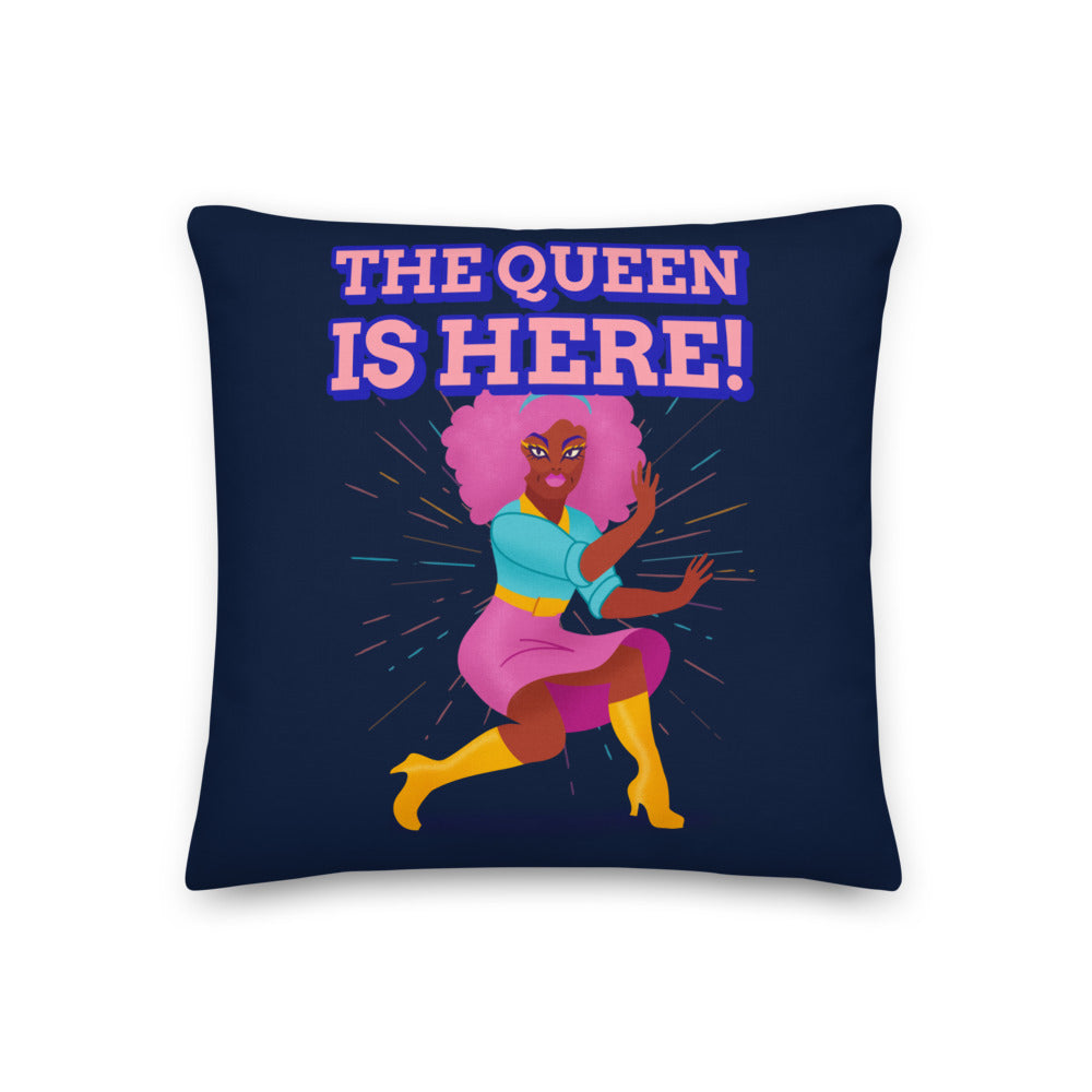 Navy decorative pillow reading “THE QUEEN IS HERE!” with a colorful illustrated queen