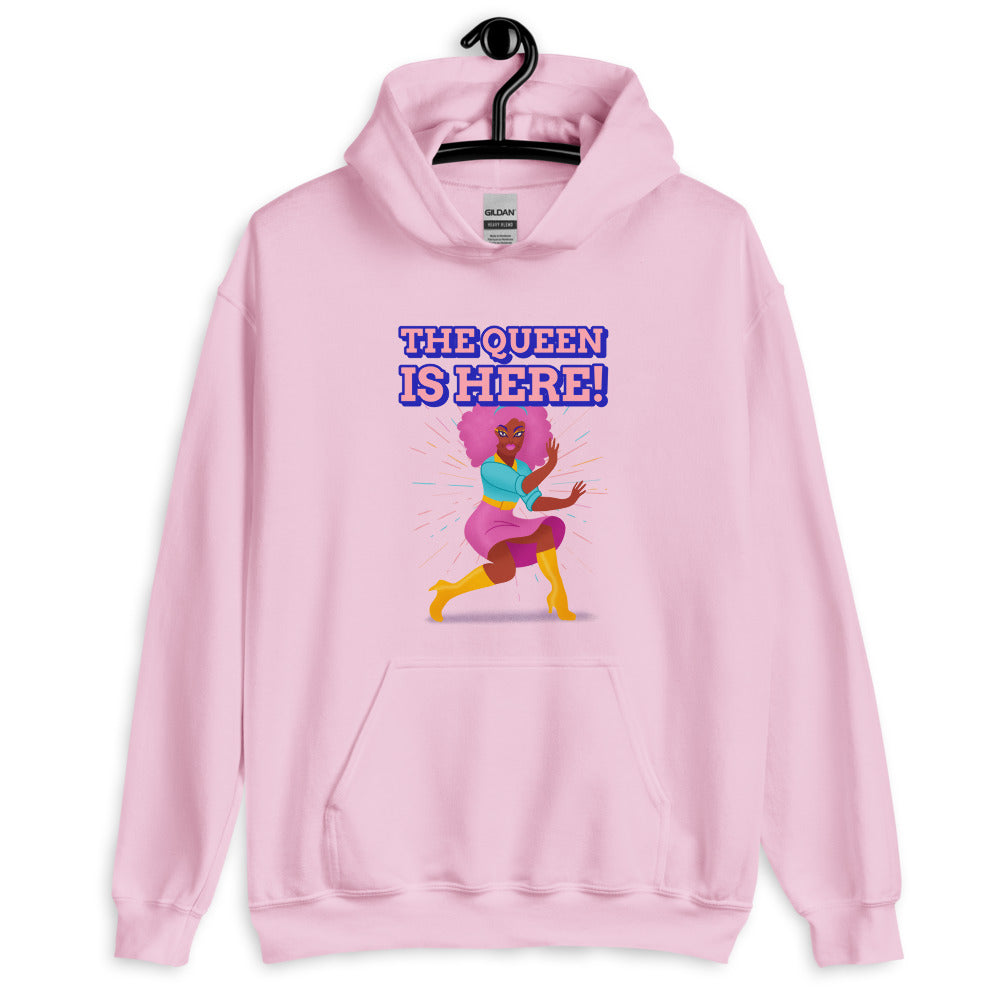 Front view of a light pink hoodie reading “THE QUEEN IS HERE!” with a colorful dancing figure