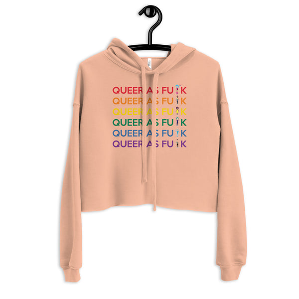 Peach cropped hoodie on a hanger with six colorful “QUEER AS F#CK” rows