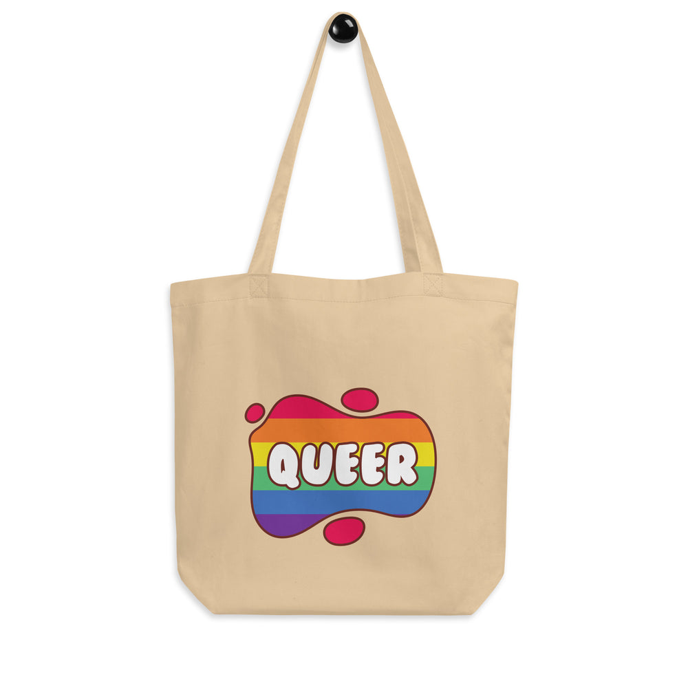 Natural canvas tote bag with rainbow-striped splash graphic reading “QUEER”