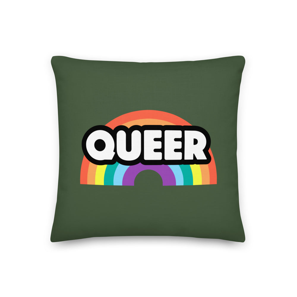 Dark green square pillow with a rainbow graphic and bold white “QUEER” lettering