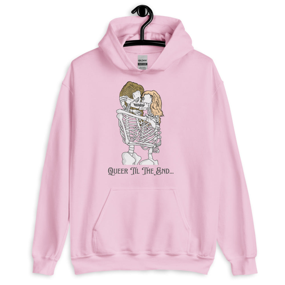 Pink hoodie on a hanger with two kissing skeletons and “QUEER TIL THE END...”