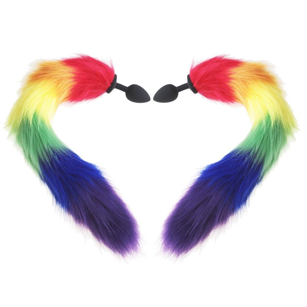 Close-up of a rainbow faux-fur tail plug with black base and pointed tip