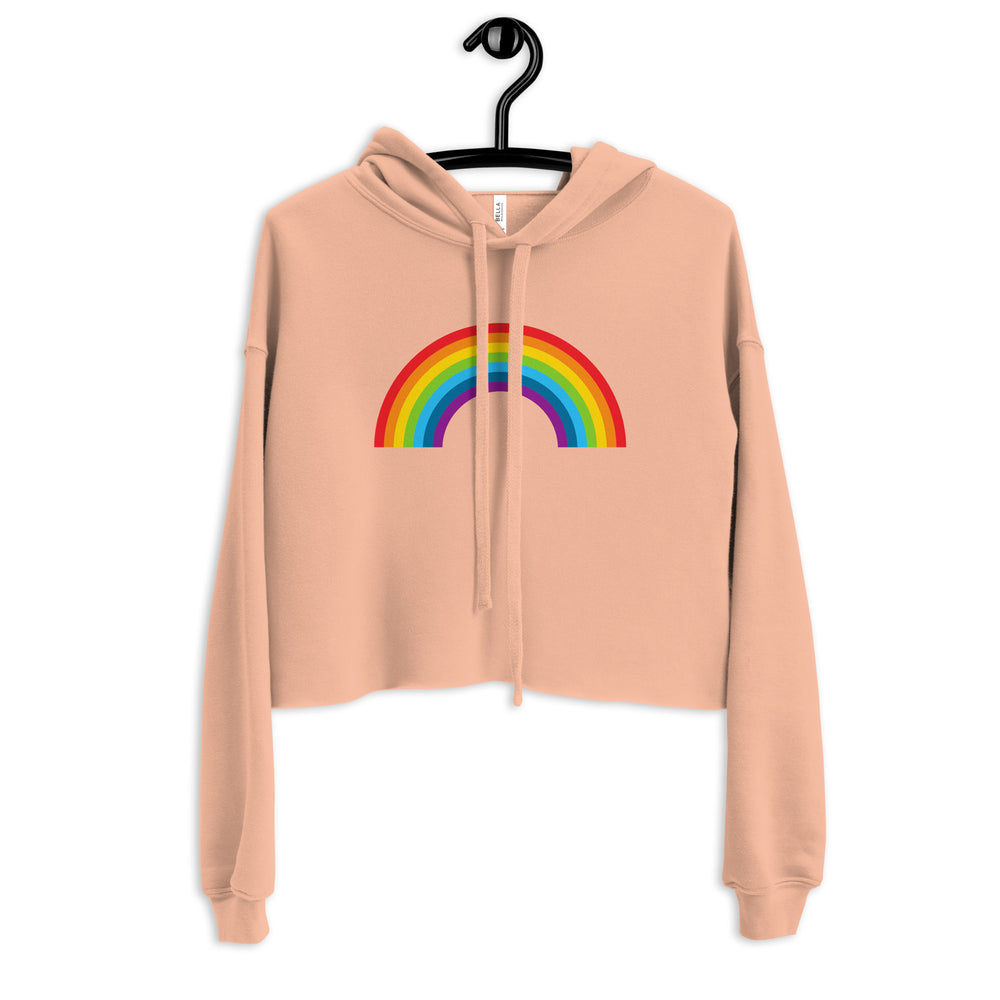 Front view of a peach cropped hoodie with a rainbow arch graphic and drawstring hood