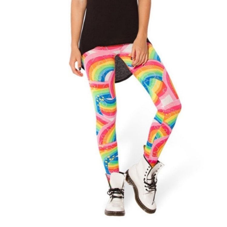 Model wearing rainbow leggings with colorful arched patterns and white lace-up boots