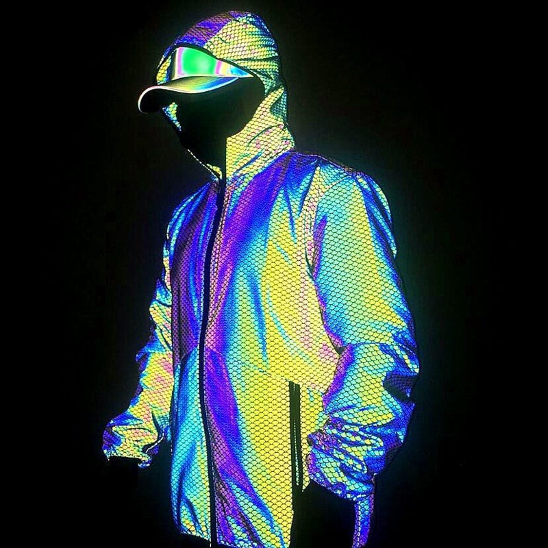 Person in profile wearing a hooded jacket with vivid rainbow reflective panels and a cap