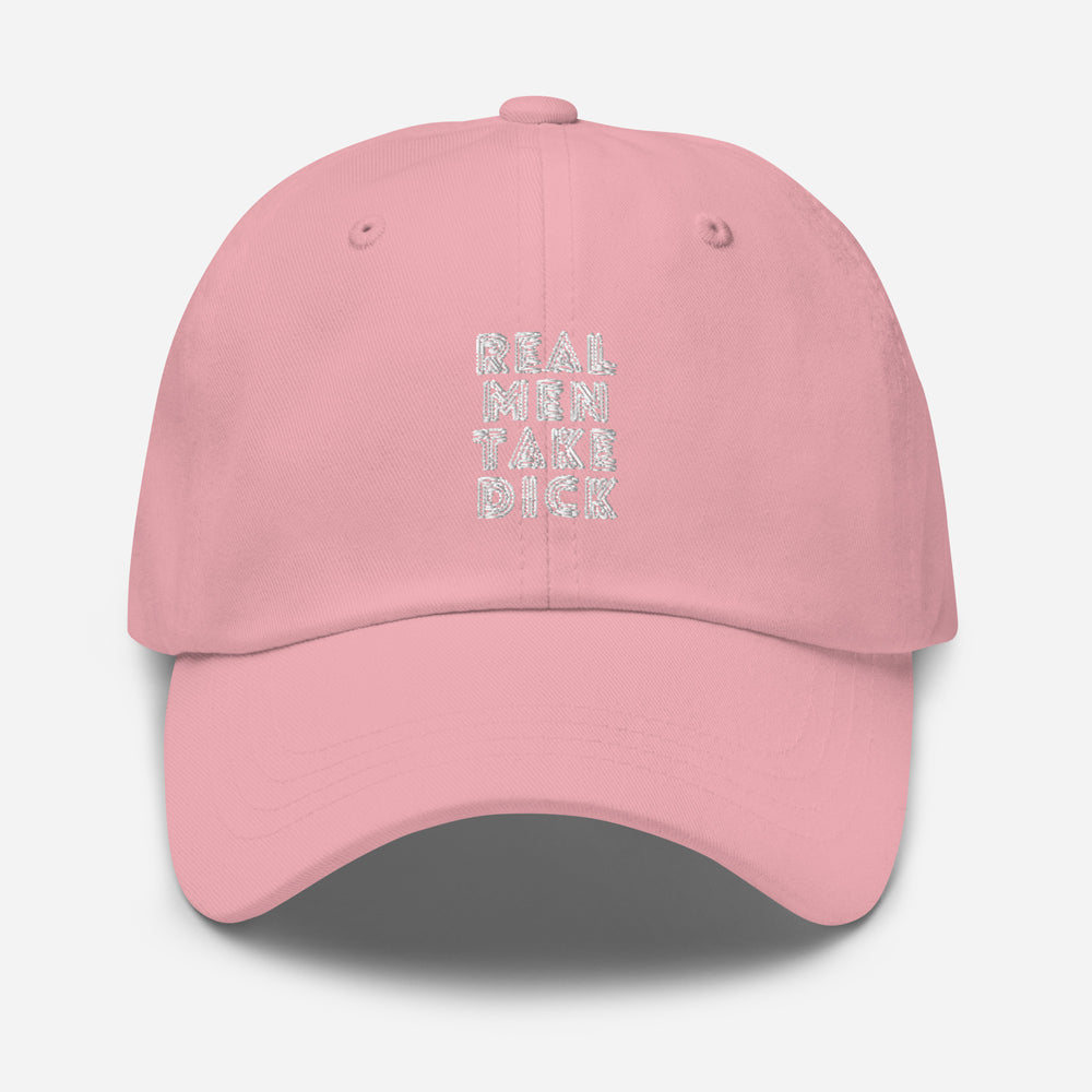 Front view of a pink cap embroidered with “REAL MEN TAKE DICK” in white
