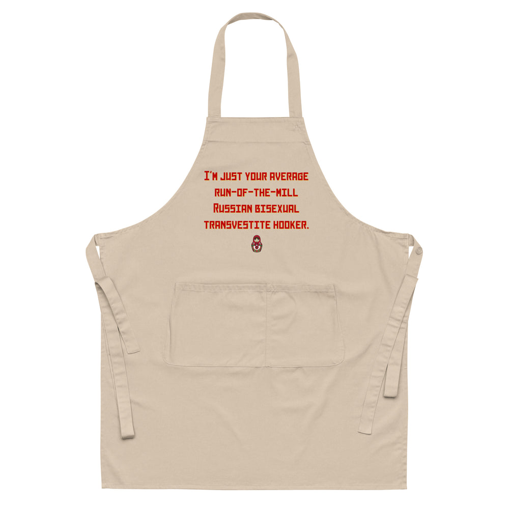 Front-facing beige apron with red text reading “I'M JUST YOUR AVERAGE RUN-OF-THE-MILL RUSSIAN BISEXUAL TRANSVESTITE HOOKER.”