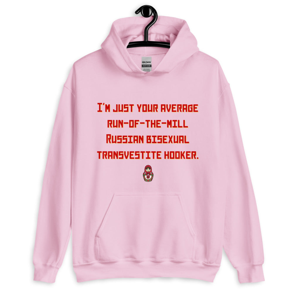 Front-facing light pink hoodie with red text and a small matryoshka graphic