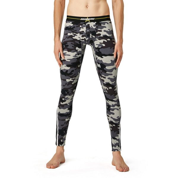Gray, black, and white camouflage thermal leggings modeled with a black waistband