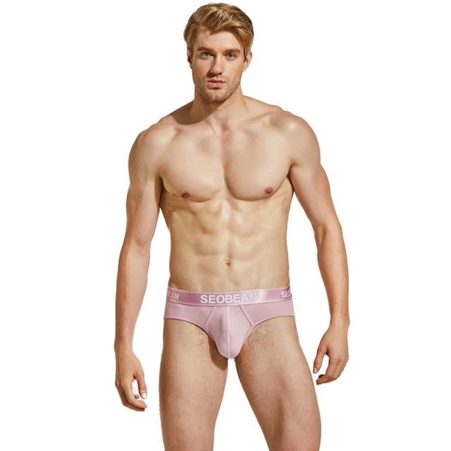Front-facing model wearing pink Seobean briefs with a branded elastic waistband