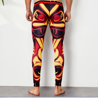 Rear view of a model wearing red, yellow, and black abstract printed leggings