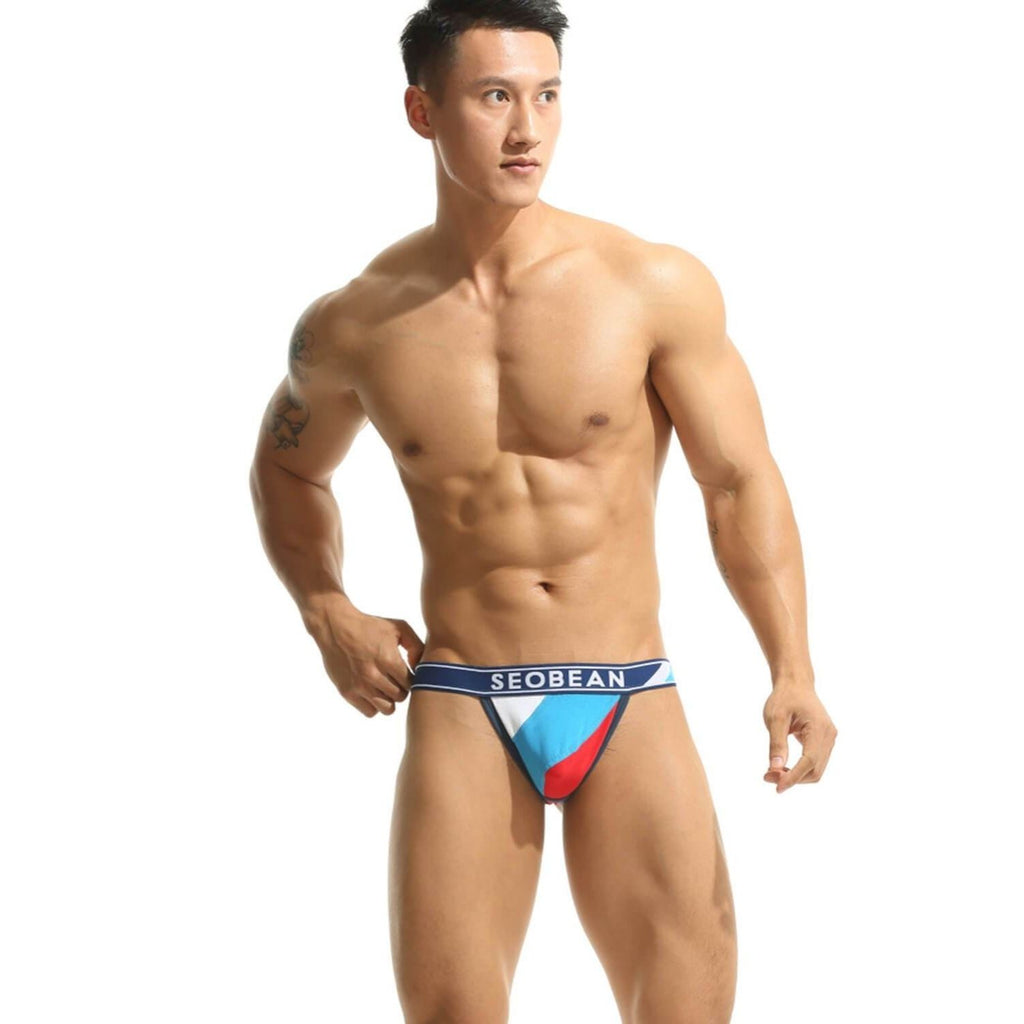 Front view of a model wearing a blue, white, and red color-block jockstrap