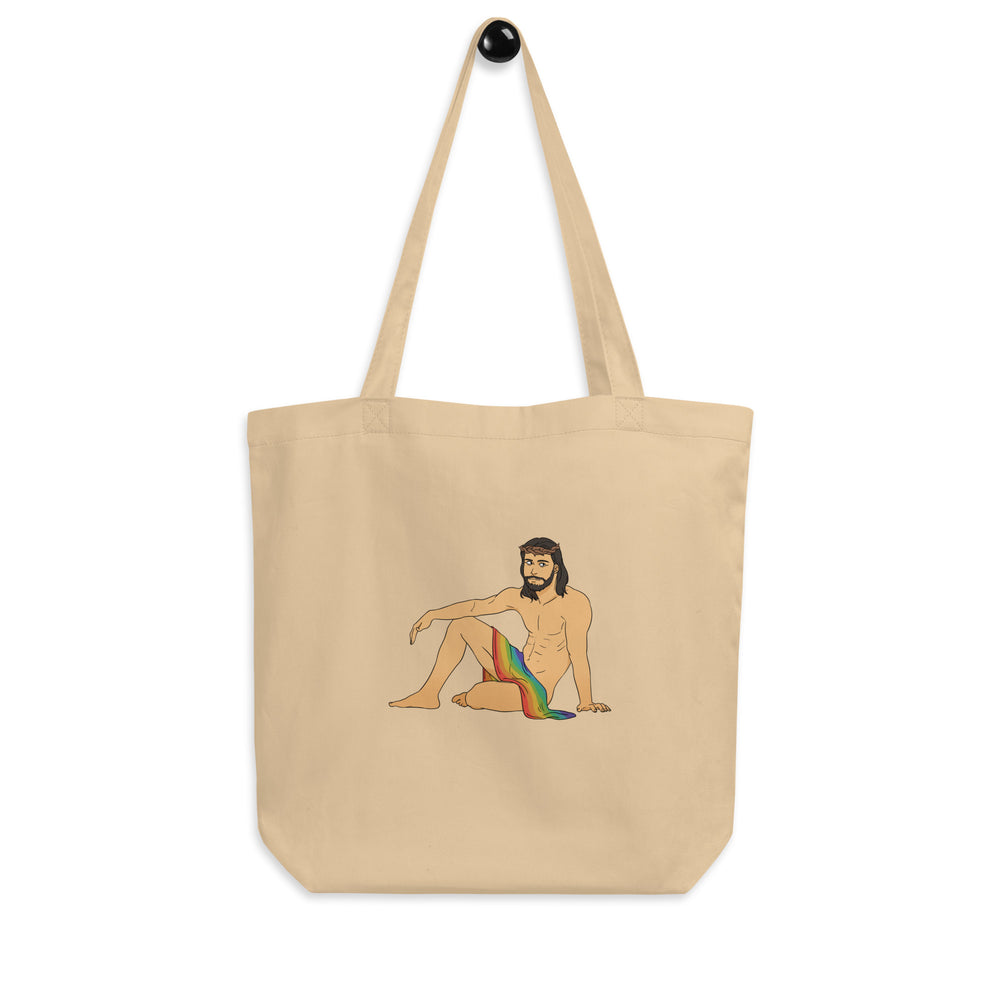 Natural canvas tote bag printed with a seated, shirtless bearded Jesus figure in rainbow fabric