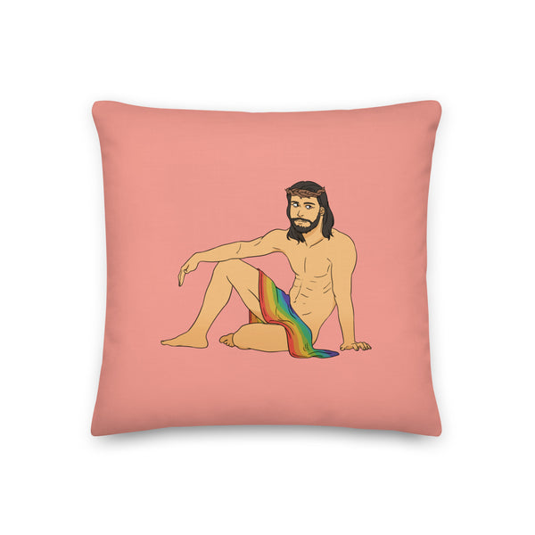 Queer Jesus Pillow featuring a nude, bearded figure with crown of thorns and rainbow flag on bold pink, yellow, and purple geometric background.
