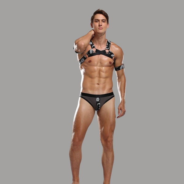 Model wearing a black camouflage harness costume with matching brief-style bottoms