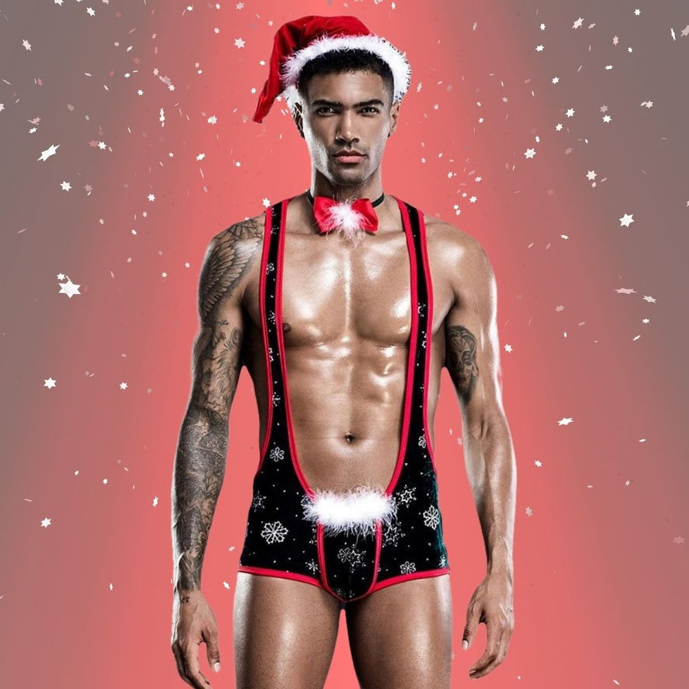 Front-facing model wearing a black Santa-themed harness romper and hat