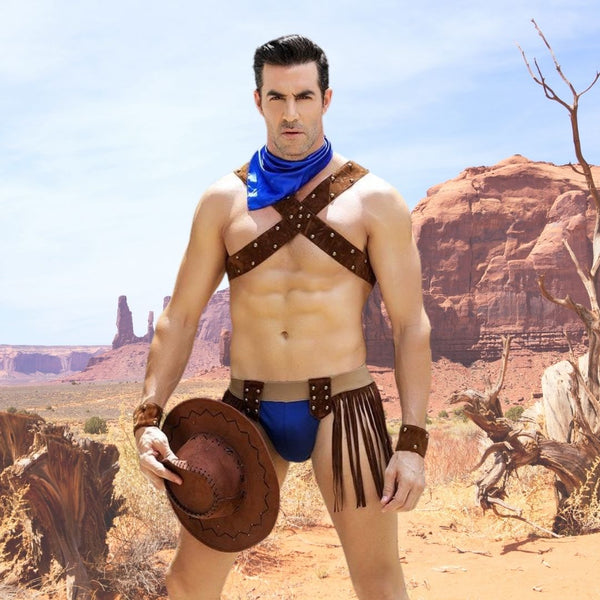 Model wearing a brown studded cowboy harness costume with blue briefs and fringe in a desert setting