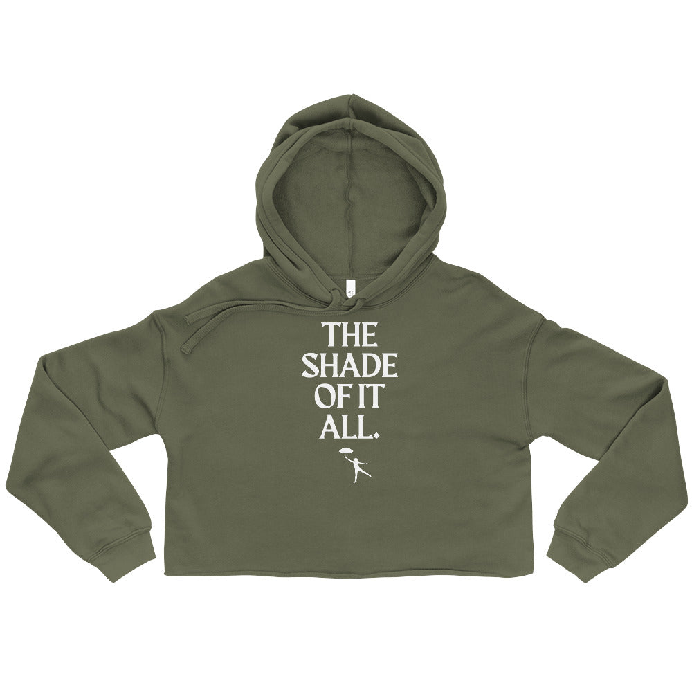 Military green cropped hoodie with white “THE SHADE OF IT ALL.” lettering and a small figure