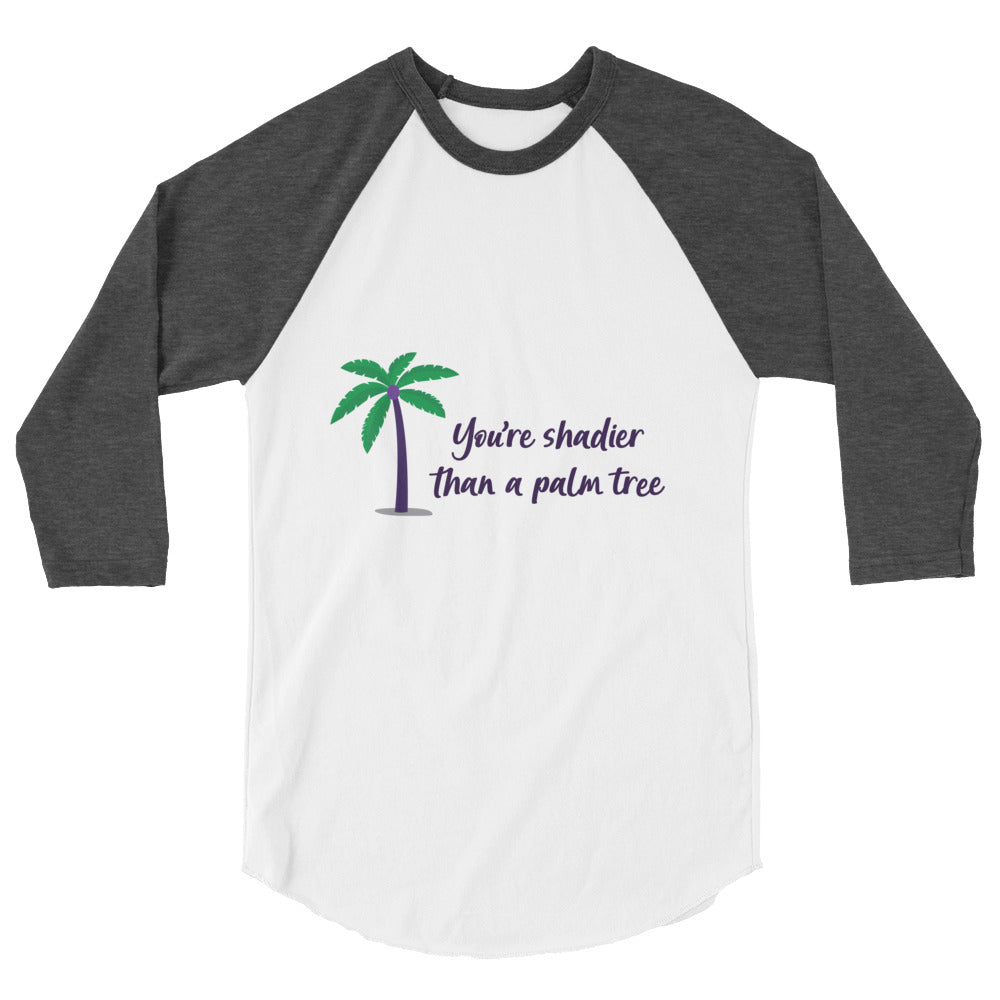 Front view of a white raglan shirt with charcoal sleeves and palm tree graphic reading “You're shadier than a palm tree.”